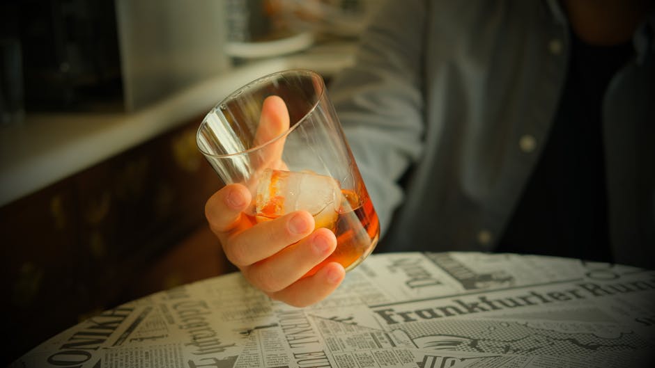 Jameson whiskey glass ice rocks close up warm light