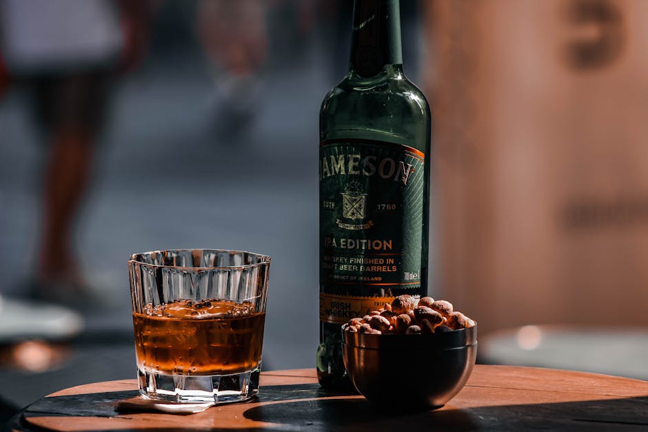 Irish whiskey bottle glass wooden table food pairing