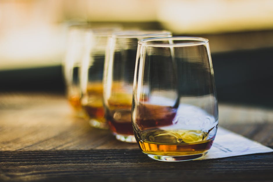 single malt whisky glass tasting flight amber color wooden table