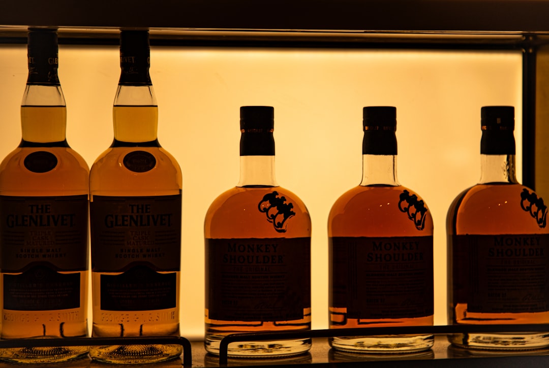 single malt whisky bottles lineup, whisky glass amber liquid