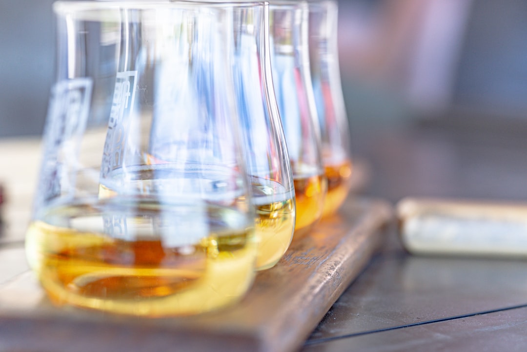 single malt whisky bottles lineup, whisky tasting glass amber